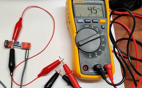 A multimeter
              connected to a voltage divider across the left and right audio
              outputs of a headphone jack showing 4.5 mV AC.