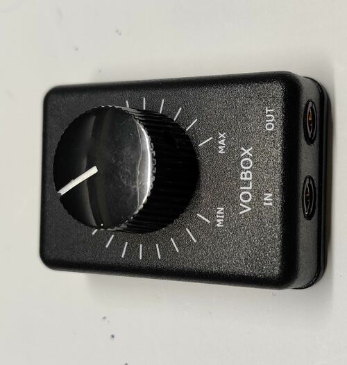 A commercial off
                the shelf audio attenuator with text MIN MAX VOLBOX IN OUT